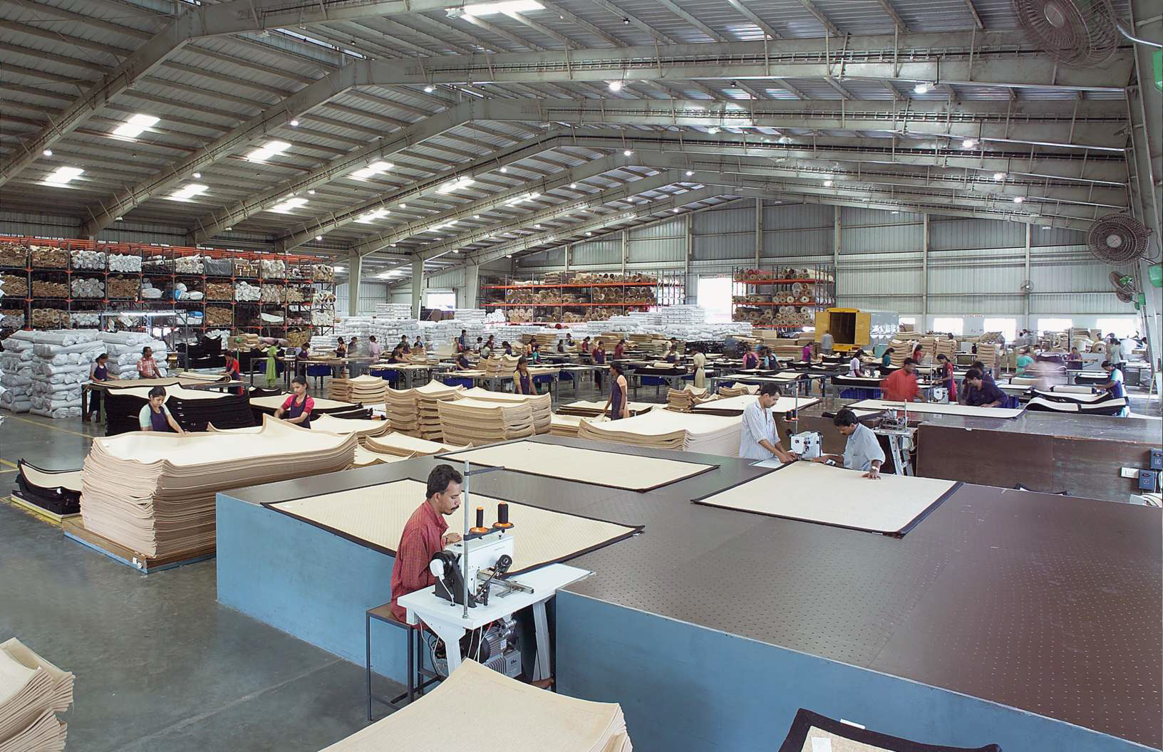 A finished, intricately woven carpet with geometric patterns.