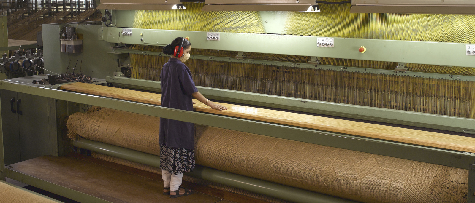 A group of people attending a weaving workshop, looking engaged.