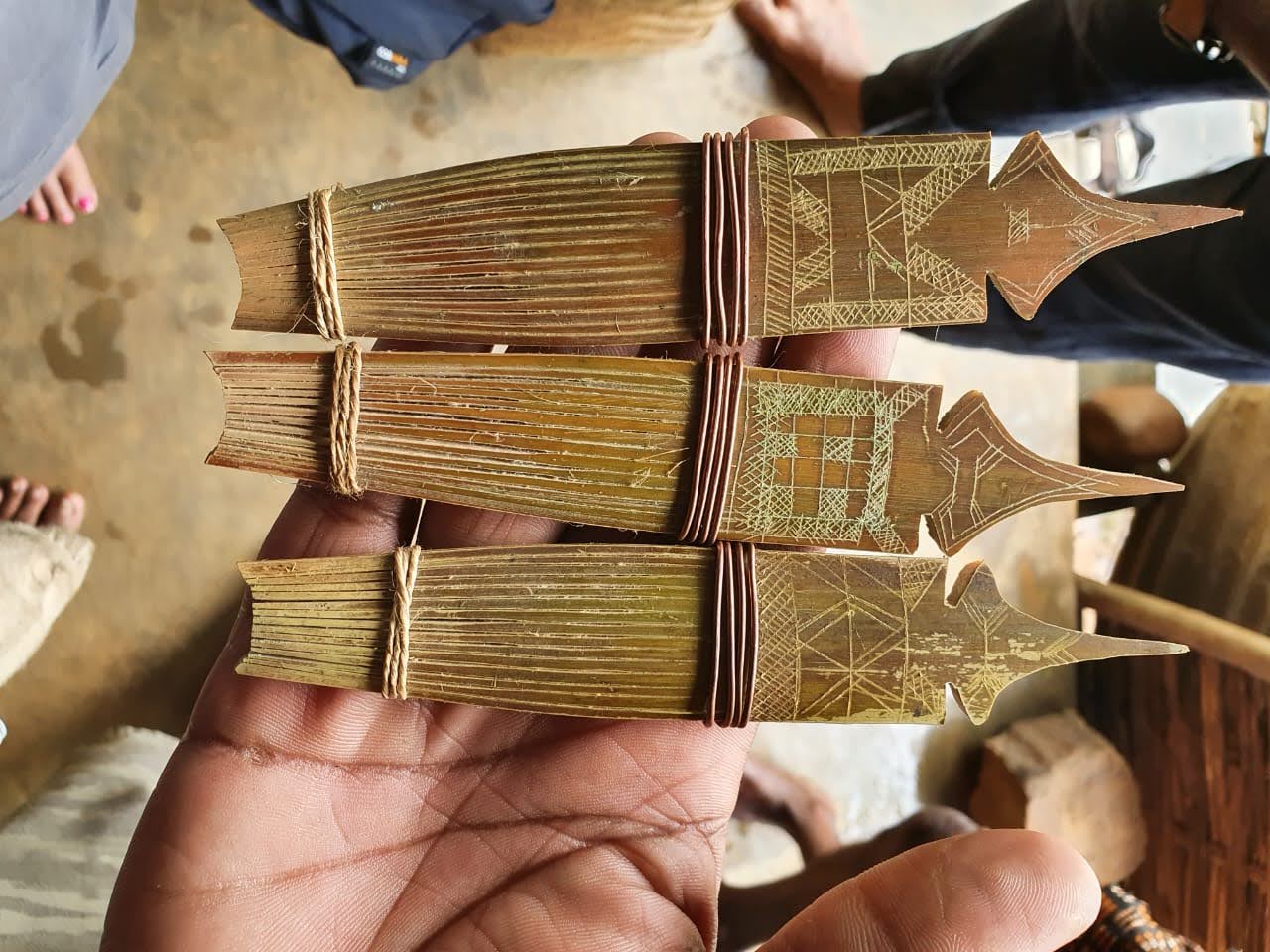 An artisan's hands carefully working with bamboo strips