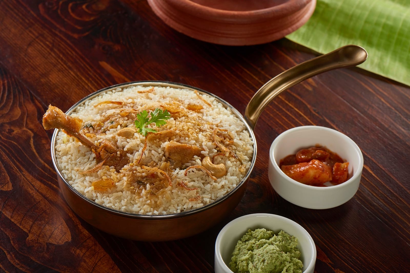 The famous Paragon fish mango curry served in a traditional clay pot.