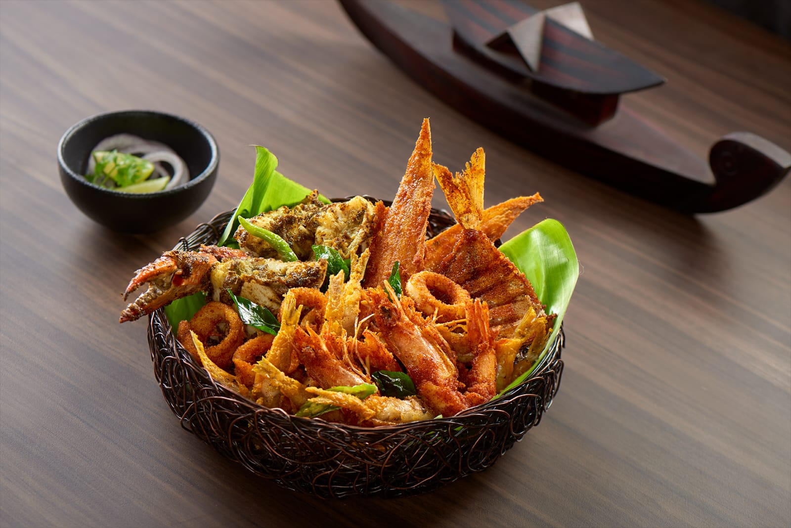 A person enjoying a traditional Sadhya meal on a banana leaf.