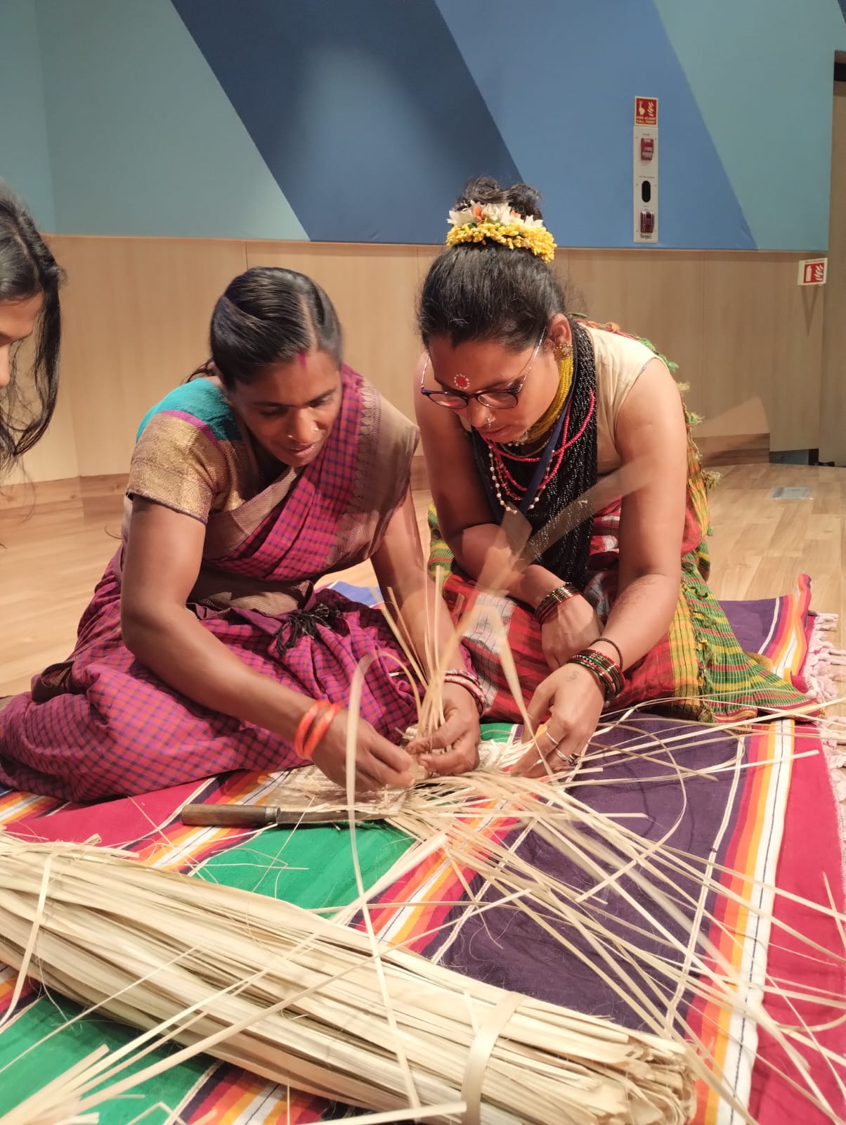 A serene backwater scene in Kerala with a houseboat gliding through the water.